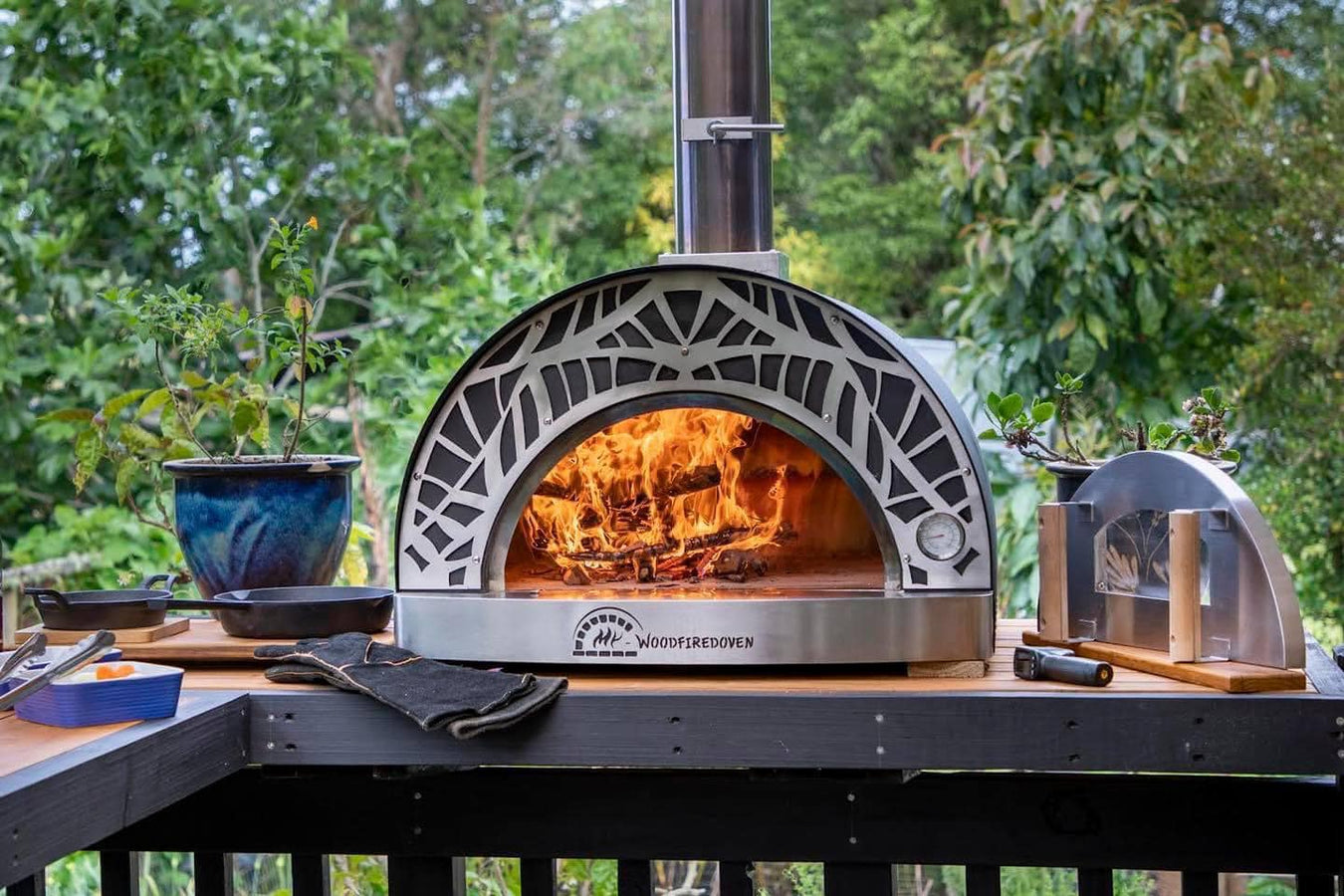 Pizza Oven on a bench with a roaring fire inside. 