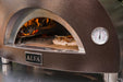 ALFA FORNI Nano Wood Pizza Oven close up view of front with fire lit inside.